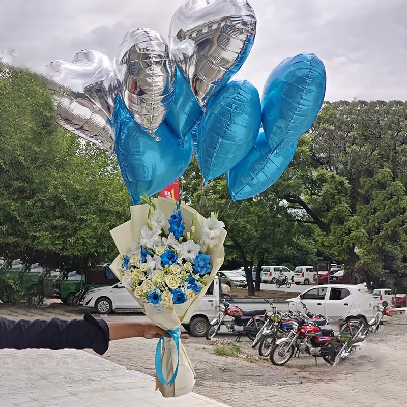 Elegant blue and white rose and Gladiolus bouquet paired with silver and blue foil heart balloons