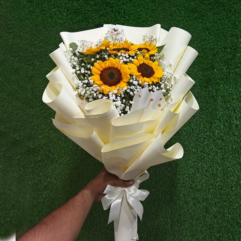 Sunflowers with Gypsophila fillers in a grand cream/white paper bouquet presentation