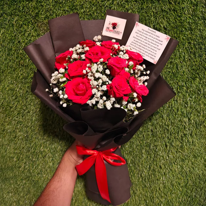 Hand-tied bouquet of red roses and baby's breath with a custom message card