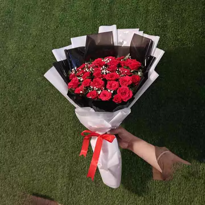Dozen red roses bouquet with white babies breath and modern black and white wrapping