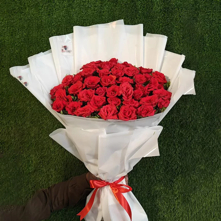 Dozen red roses bouquet with white babies breath and modern black and white wrapping