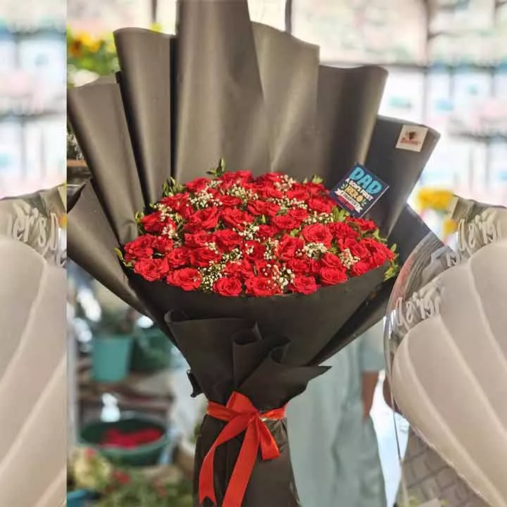Massive 100 red roses bouquet in black paper with a "DAD" greeting card, suitable for special occasions