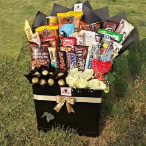 Extra-large black gift box/bucket filled with branded snacks, chocolates, and white roses