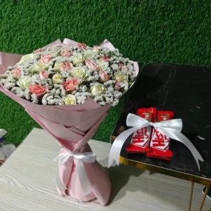 Luxurious bouquet of baby pink and white spray roses with Gypsophila, plus two KitKat bars