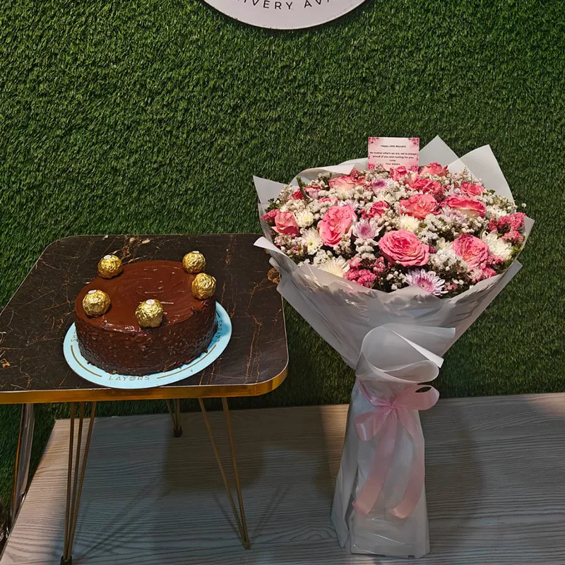 Mixed pink roses and fillers bouquet with a chocolate Ferrero Rocher cake