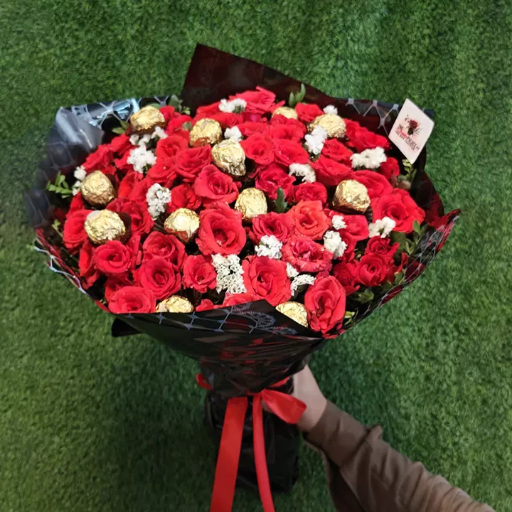Grand bouquet of red roses, white fillers, and Ferrero Rocher chocolates for anniversary gift