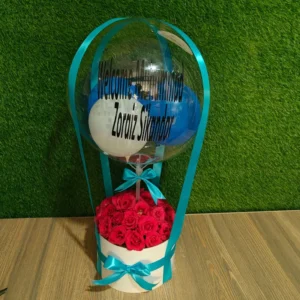 Hot air balloon gift box with red roses and custom "Welcome" message for a newborn