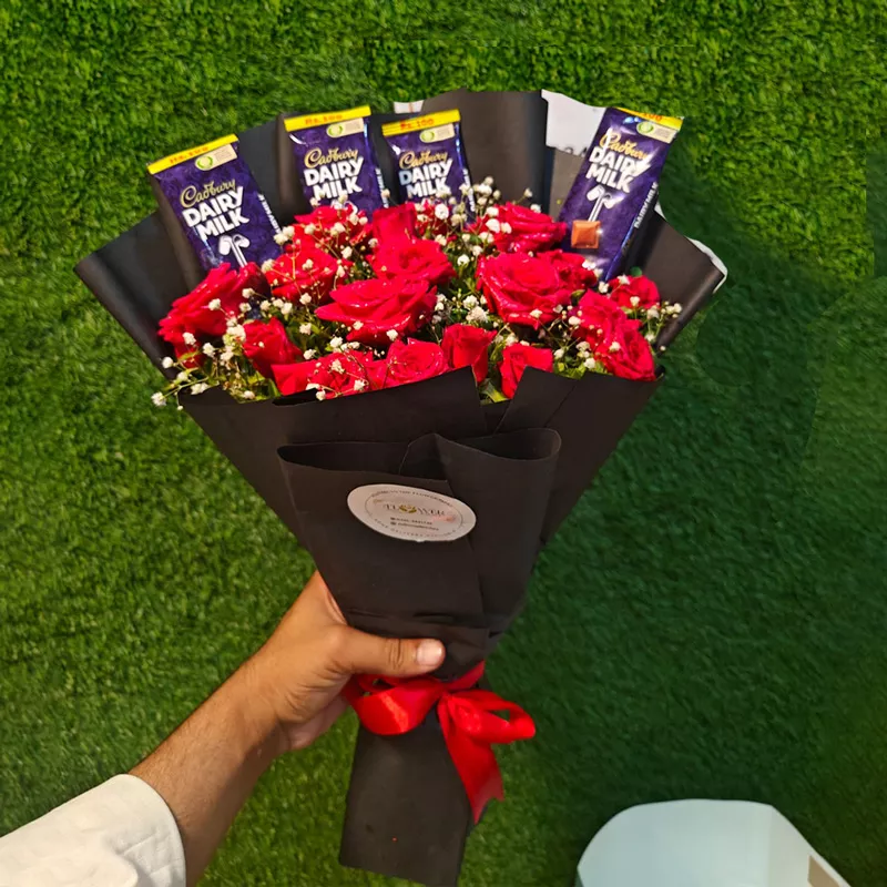 Red roses bouquet with Cadbury Dairy Milk chocolate bars in black paper wrap