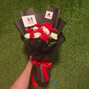 Dozen Red and White roses bouquet wrapped in black paper with a red ribbon for Valentine's or Birthday