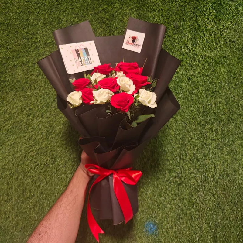 Dozen Red and White roses bouquet wrapped in black paper with a red ribbon for Valentine's or Birthday