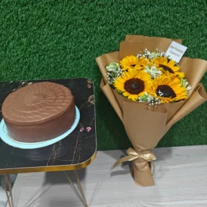 Sunflowers bouquet in Kraft paper wrap paired with a round chocolate cake for celebration