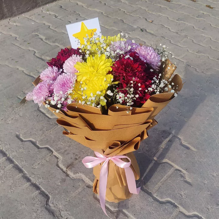 Mixed Chrysanthemum (Mums) bouquet in yellow, red, and purple with brown Kraft paper wrap