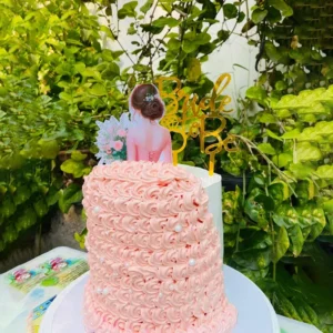 Pink rosette bridal shower cake designed like a wedding dress gown train