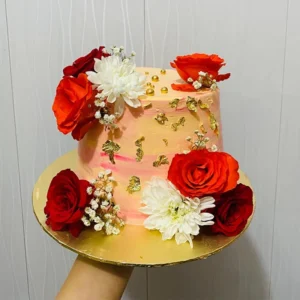 Fresh red rose cake with gold flakes and textured cream buttercream frosting