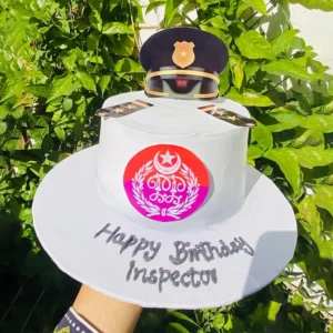 Police inspector profession cake with white frosting and officer uniform cap topper
