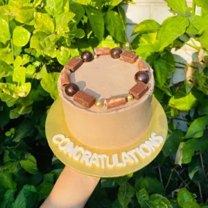 Chocolate congratulations cake with Ferrero Rocher truffles and gold leaf accents