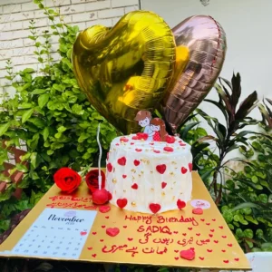 Anniversary calendar cake with highlighted date and romantic couple silhouette topper