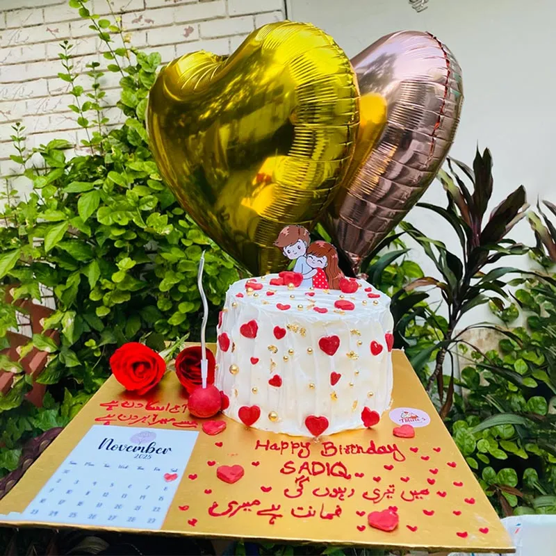 Anniversary calendar cake with highlighted date and romantic couple silhouette topper